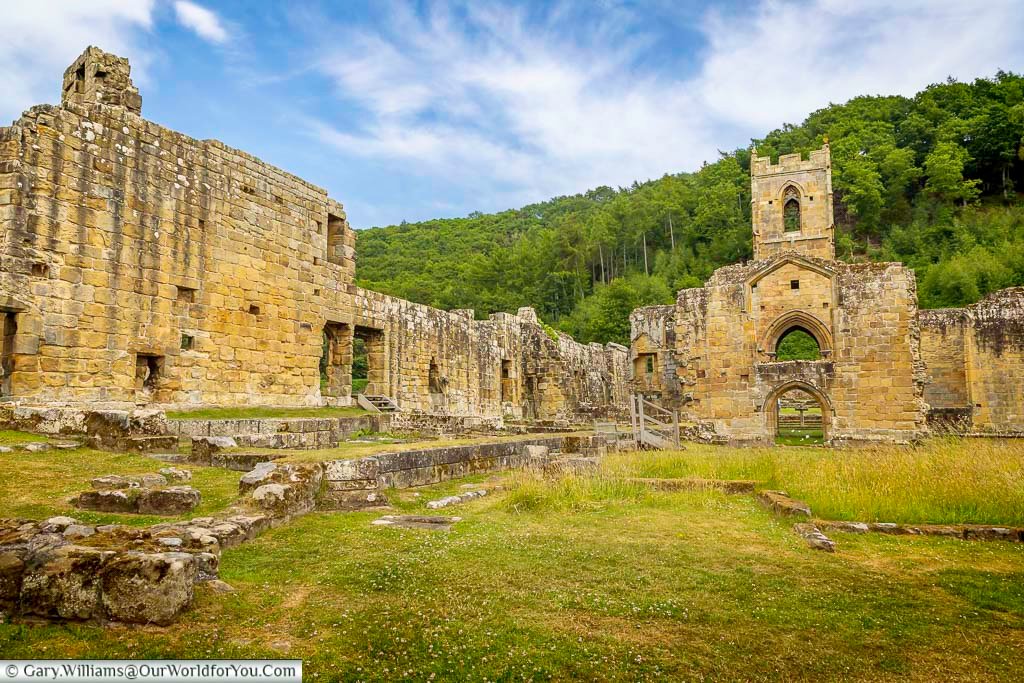 The sweeping ruins of Mount Grace Priory stretch across a peaceful valley in North Yorkshire, surrounded by woodland hills. This medieval Carthusian monastery is one of the best preserved priory sites in England.