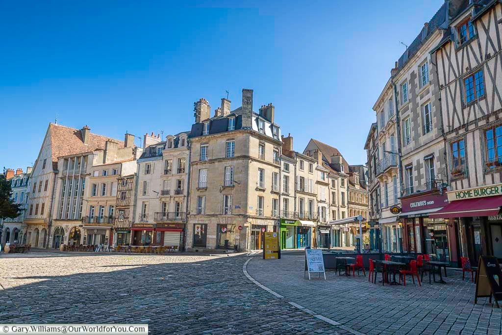 Beautiful historic buildings surround a cobbled square in the old town of Poitiers, France. The charming cafés and medieval architecture make this lively square a perfect place to experience the atmosphere of the historic city.