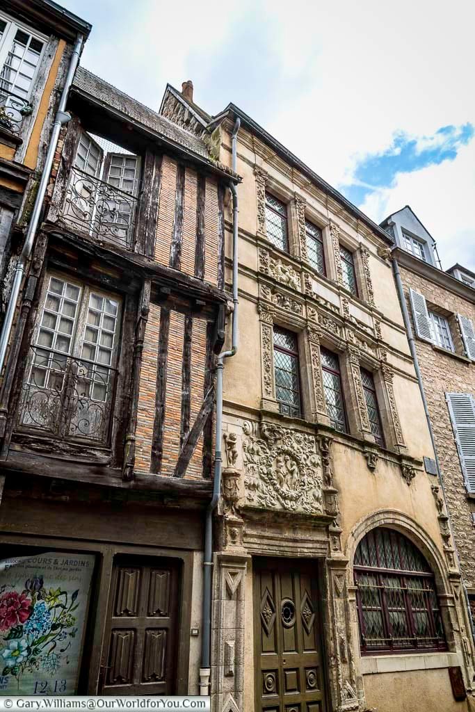 The façade of the Maison d’Adam et Ève in Le Mans combines timber-framed architecture with intricate stone detailing. This iconic medieval building is a key highlight for visitors exploring the historic old town of Le Mans, France.