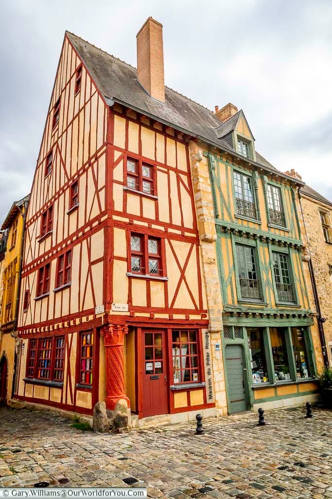 Colourful half-timbered houses line Rue du Pilier Rouge in the historic old town of Le Mans. This picturesque street showcases traditional medieval architecture and is a highlight of any walking tour in France.