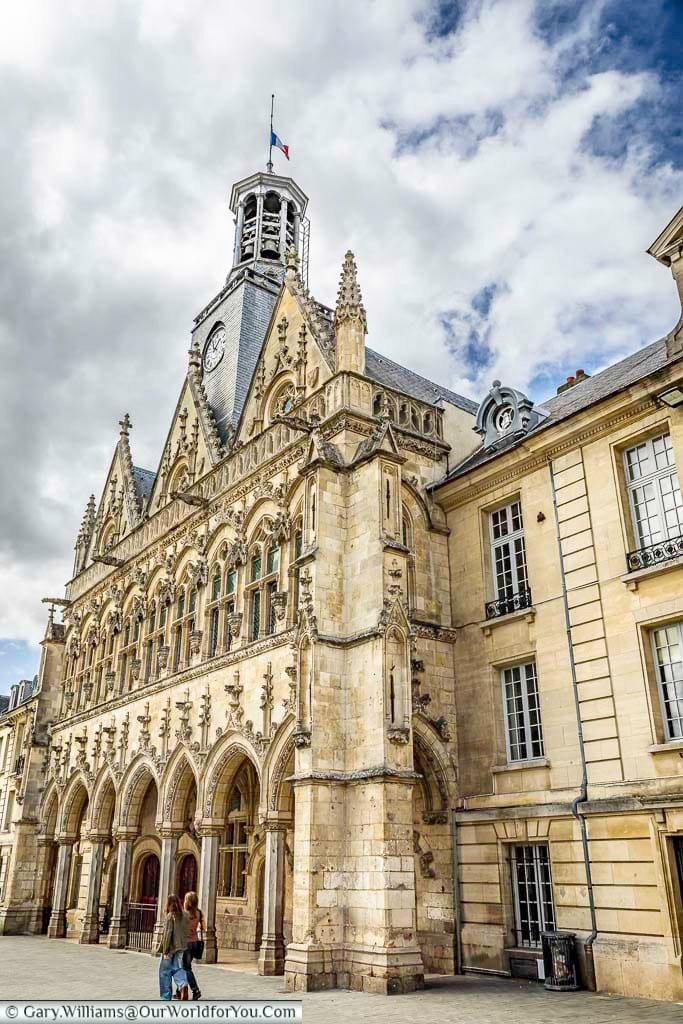 The ornate façade of the Hôtel de Ville in Saint-Quentin showcases intricate Gothic Revival architecture, detailed stone carvings, and a striking clock tower in the historic city centre. This magnificent town hall is one of the most photographed landmarks in Saint-Quentin and a key attraction for visitors touring northern France.
