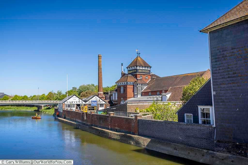 Harvey’s Brewery in Lewes sits beside the River Ouse, with its iconic brick buildings and brewery tower standing out against a clear blue sky. One of the most famous breweries in Sussex, Harvey’s is a must-visit destination in Lewes for real ale enthusiasts and travellers exploring historic England.