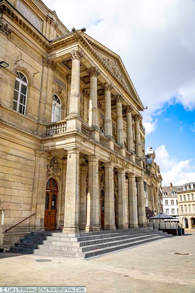 The elegant Jean Vilar Theatre in Saint-Quentin, France, features grand neoclassical architecture with towering columns and ornate stone detailing in the heart of the historic city centre. This beautifully restored cultural landmark is a must-see attraction for visitors exploring Saint-Quentin walking tours, French architecture, and cultural city breaks in northern France.