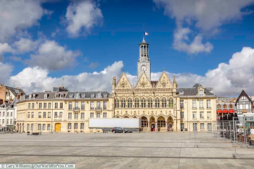 The grand Place de l’Hôtel de Ville in Saint-Quentin, France, showcases elegant historic architecture and the striking Gothic-style town hall beneath dramatic blue skies. This iconic city square is a must-visit destination for travellers exploring Saint-Quentin walking tours, French heritage sites, and cultural city breaks in northern France.