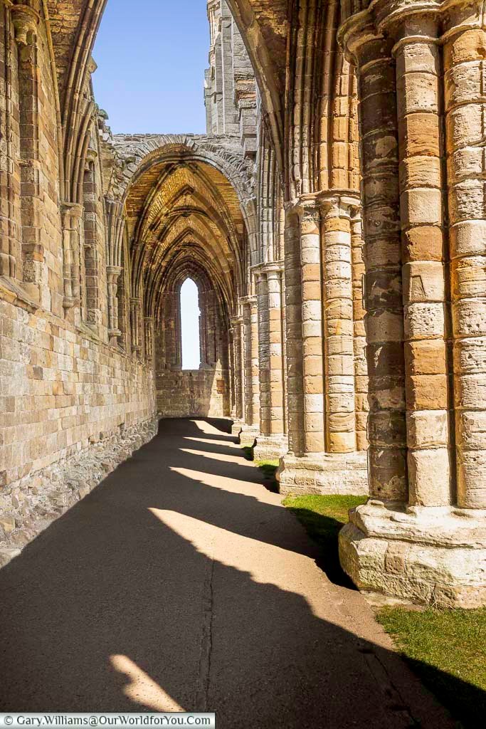 Sunlight illuminates the intricate stone arches and medieval architecture of Whitby Abbey’s early 13th-century ruins. These beautifully preserved remains offer a glimpse into the abbey’s rich past and make Whitby one of Yorkshire’s premier historic destinations.