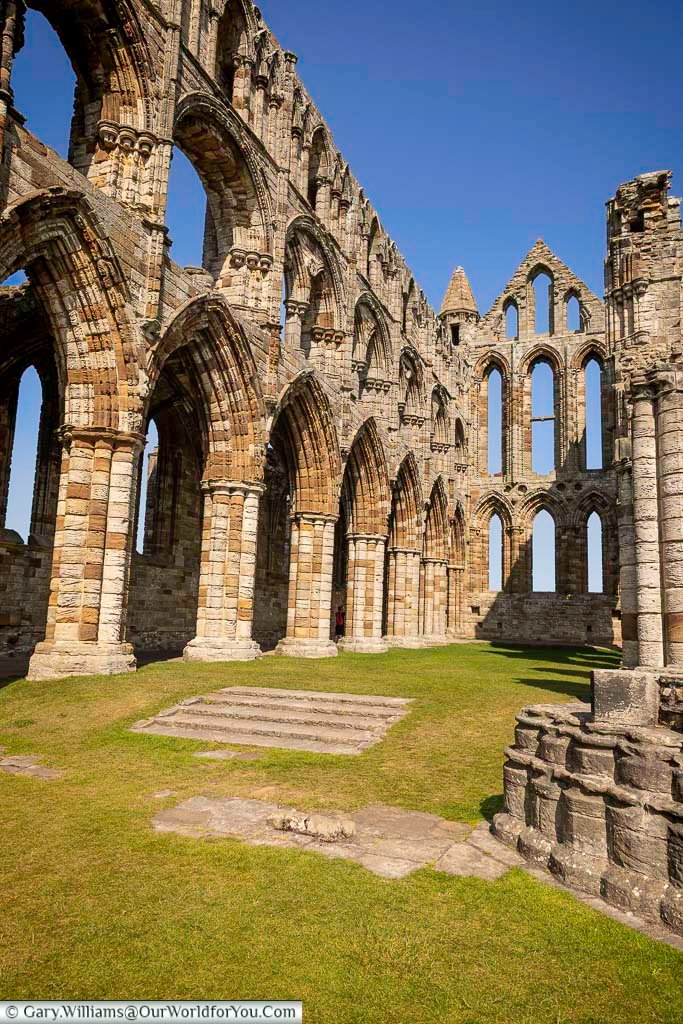 The soaring arches and towering windows of Whitby Abbey’s choir and sanctuary reveal the scale and craftsmanship of this medieval masterpiece. This striking viewpoint highlights the abbey’s Gothic architecture and is a favourite spot for visitors exploring Whitby’s heritage.