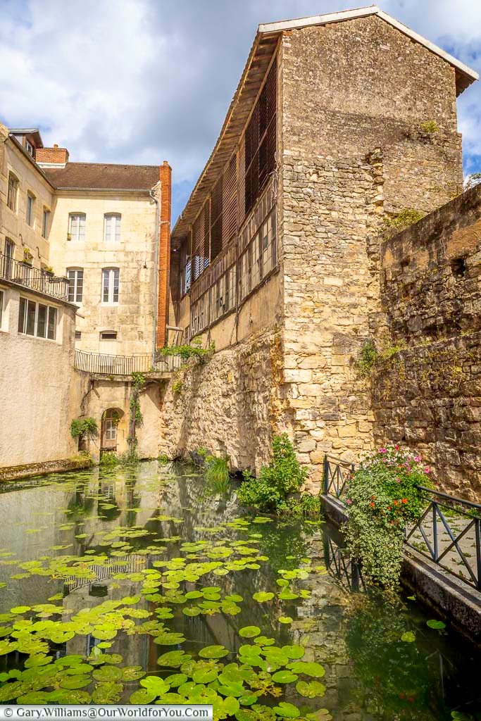 Historic stone buildings line the Canal des Tanneurs, reflecting Dole’s medieval character and centuries of riverside heritage. This charming canal-side scene is one of the town’s hidden gems and a beautiful stop on a scenic tour of Dole in eastern France.