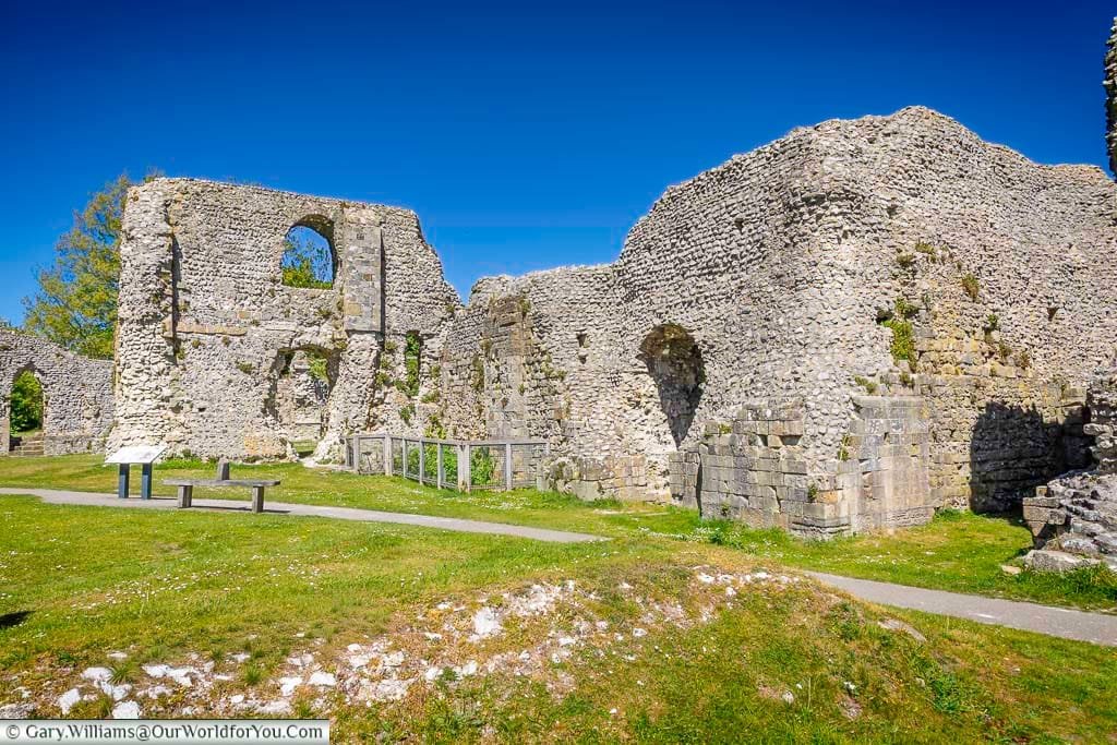 The extensive ruins of Lewes Priory spread across a peaceful green space, with the South Downs forming a beautiful backdrop to this historic site.