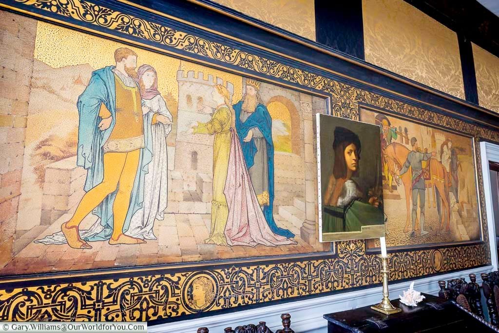 Richly decorated interior of the King's Bed Chamber at Restoration House, featuring historic wall hangings, artwork and elaborate period decoration.