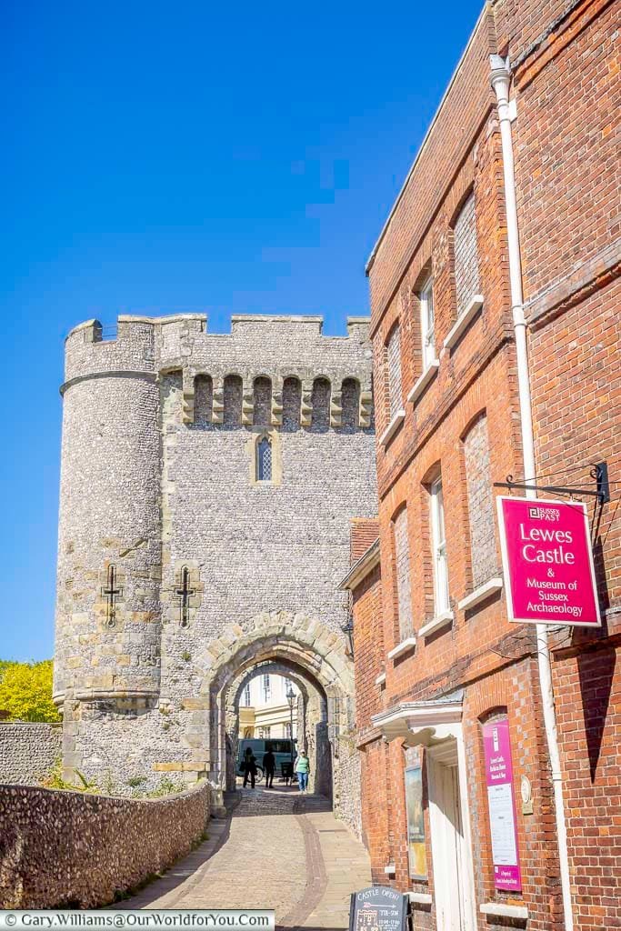 The approach to Lewes Castle and the Museum of Sussex Archaeology, with the medieval Barbican towering above the narrow historic entrance.