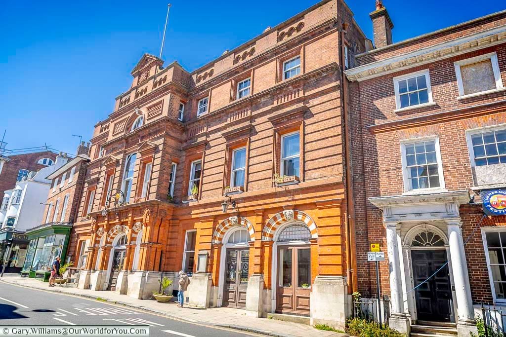The impressive red-brick façade of Lewes Town Hall on the High Street, an elegant Victorian landmark at the heart of the historic town centre.