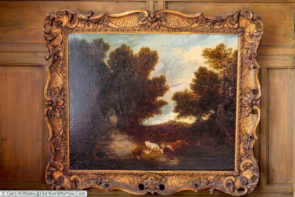 One of the historic Gainsborough paintings displayed at Restoration House in Rochester, showing a pastoral landscape in an ornate gilded frame.