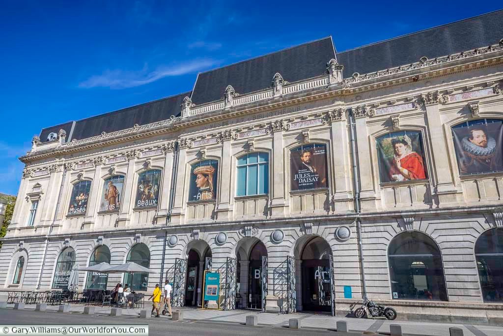 The elegant façade of the Musée des Beaux-Arts de Chambéry, one of the city’s principal cultural attractions, beneath a vivid blue Alpine sky. The fine arts museum occupies the former grain hall and houses an important collection particularly noted for its Italian paintings.