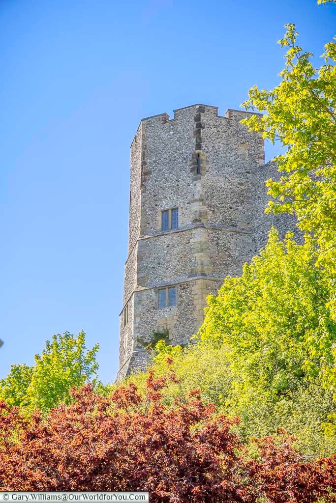 One of the great flint-built towers of Lewes Castle rising above the trees, a striking reminder of the town’s Norman and medieval past.
