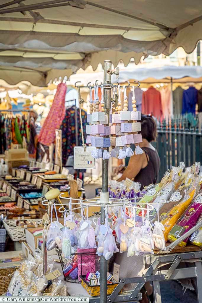 Handmade Provençal soaps, perfumes and lavender products displayed on a colourful market stall in Saint-Rémy-de-Provence, France.