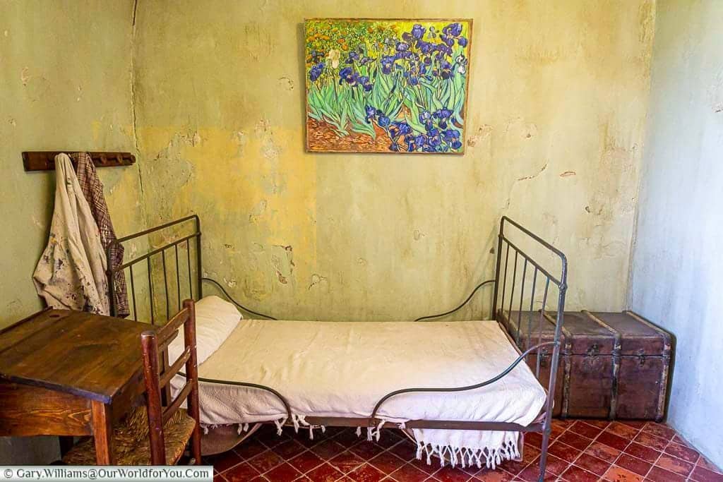 Recreated room of Vincent van Gogh at Saint-Paul-de-Mausole, with a simple iron bed and a reproduction of his Irises painting.