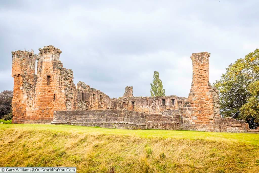 The impressive red sandstone ruins of Penrith Castle stand against a cloudy Cumbrian sky, surrounded by green parkland. This medieval fortress is one of Penrith’s best-known historic attractions and a fascinating place to explore.